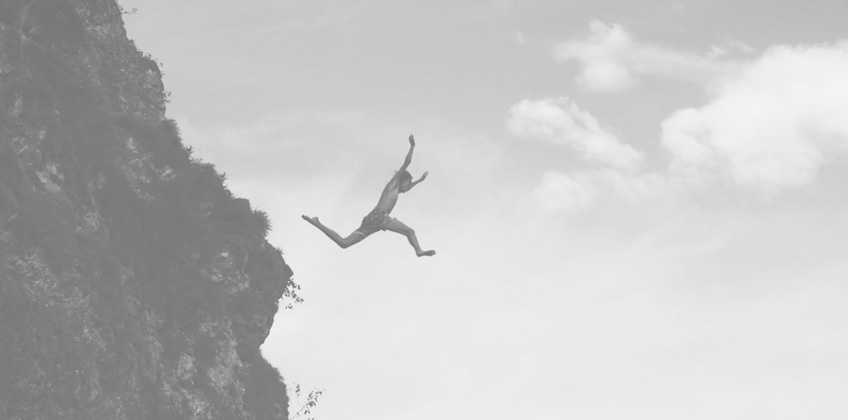 Man jumping from cliff
